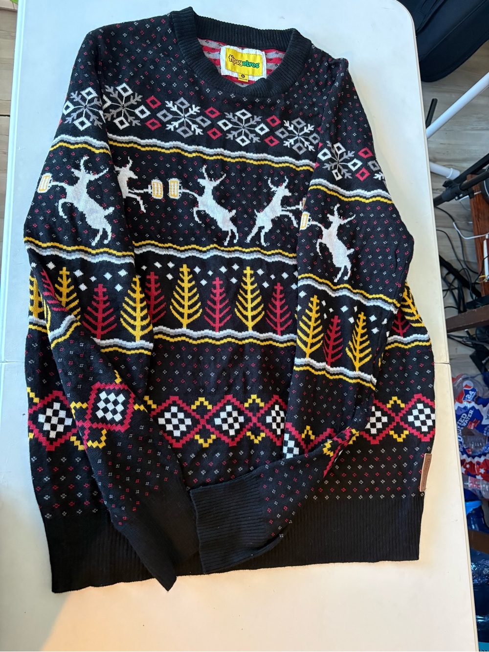 Tipsy Elves Black Crewneck Sweater with White Reindeer and Yellow & Red Accents